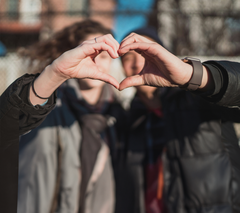 two people making a heart shape with their hands at The Oxford