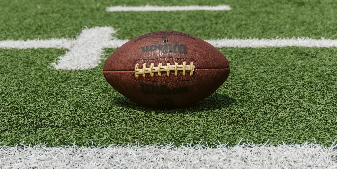 an american football sits on the field at The Oxford